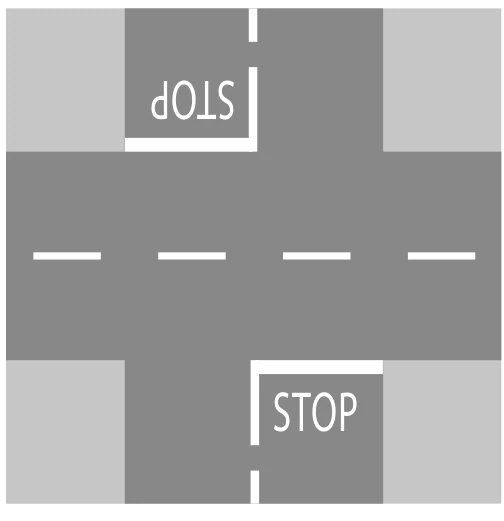 Palabra STOP pintada antes de una intersección
